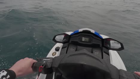 POV-shot-of-a-jet-skier-doing-donuts-in-the-ocean-and-then-taking-off