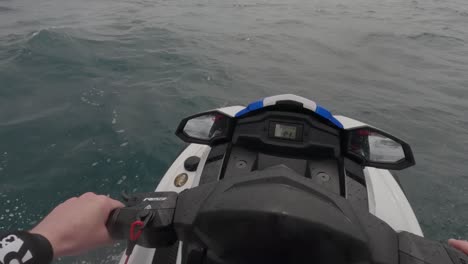 pov shot of a jet skier doing donuts in the ocean and then taking off