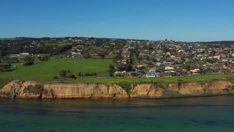 aerial truck right along rugged coastline of clifton springs australia