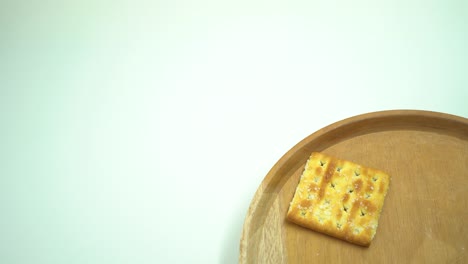 christmas cracker biscuit over the wooden plate, fork and spoon with white background.