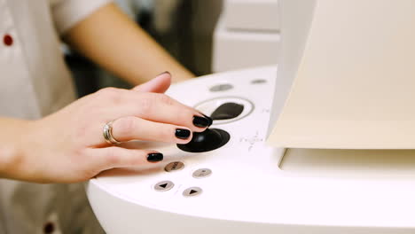 modern medical equipment. close up of hand working on modern medical equipment in operating room