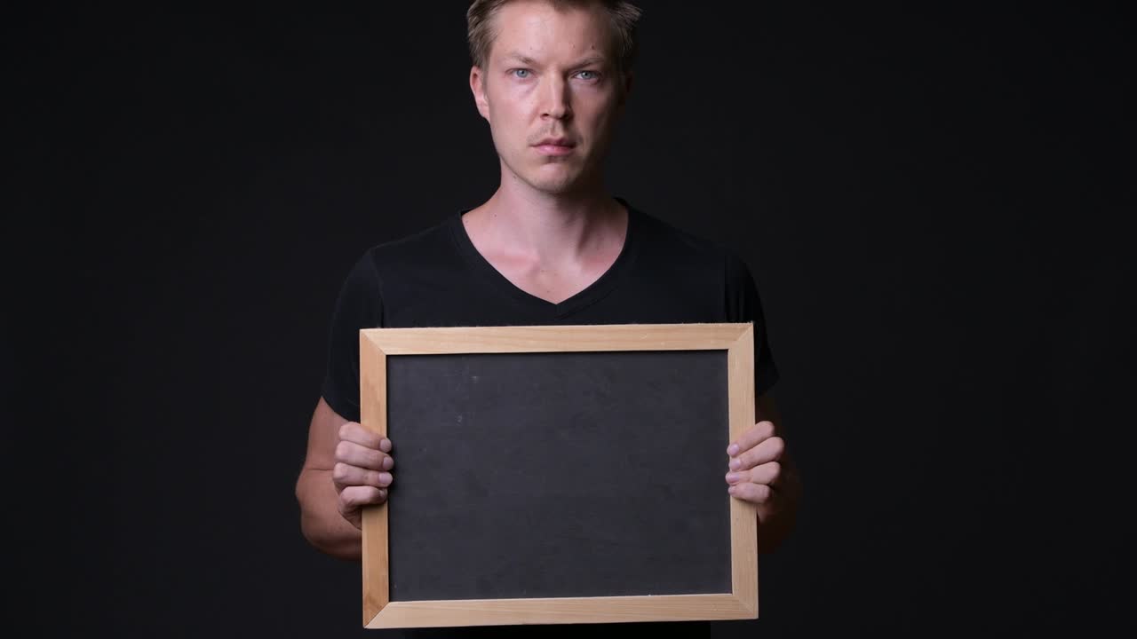 Man Holding Empty Blackboard