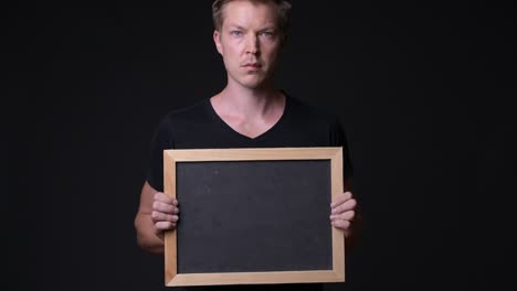 man holding empty blackboard