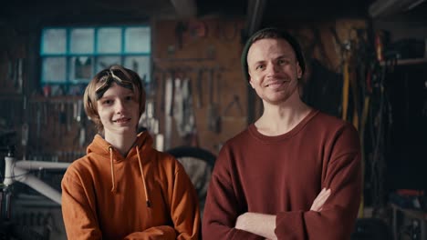 industrial mastery: a teen and mechanic's dedication. master and his young assistant posing against the backdrop of the workshop