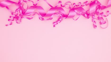 woman hand put birthday card, open it and put gifts under pink ribbons. stop motion