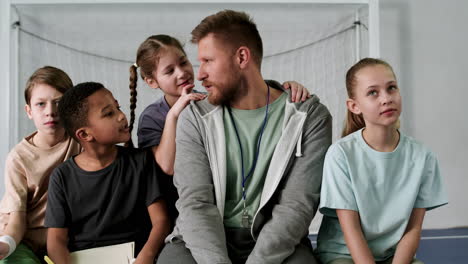 man and children at the soccer field