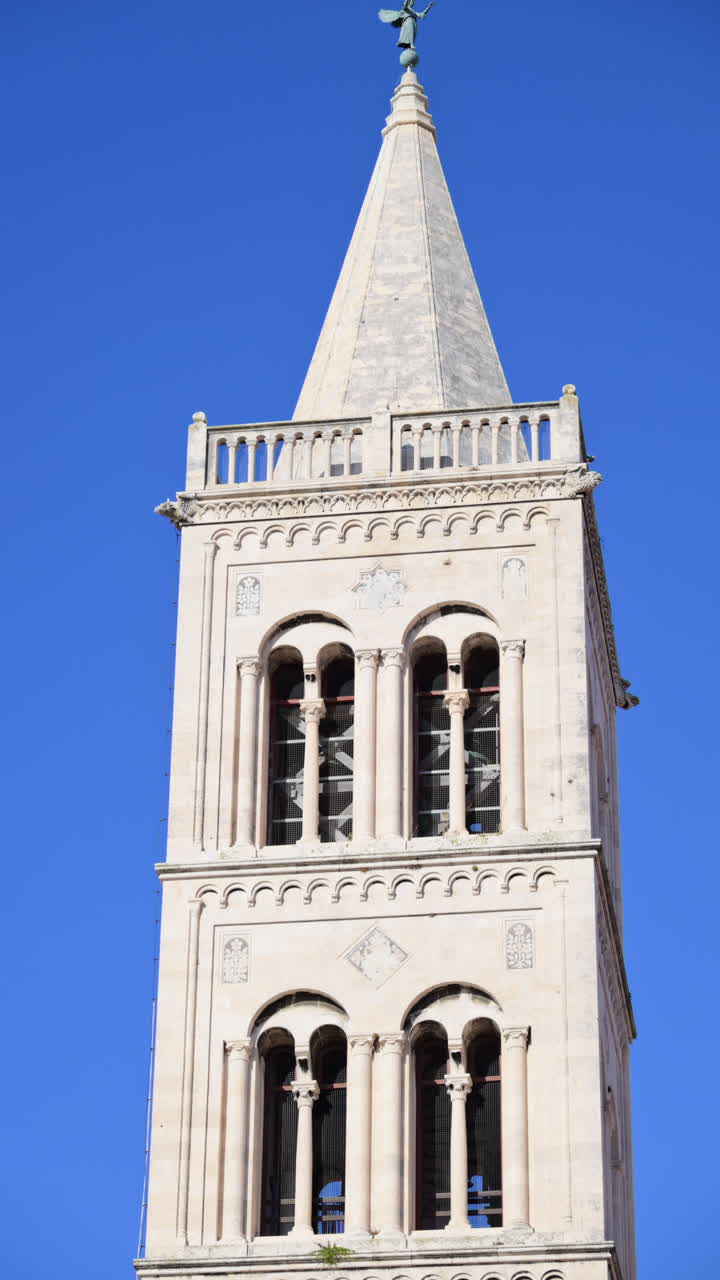 Romanesque bell tower of St. Anastasia's Cathedral in Zadar against a clear blue sky. Croatia