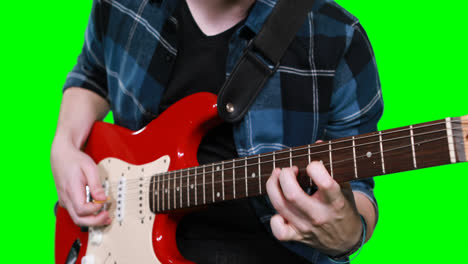 Mid-section-of-male-musician-playing-guitar