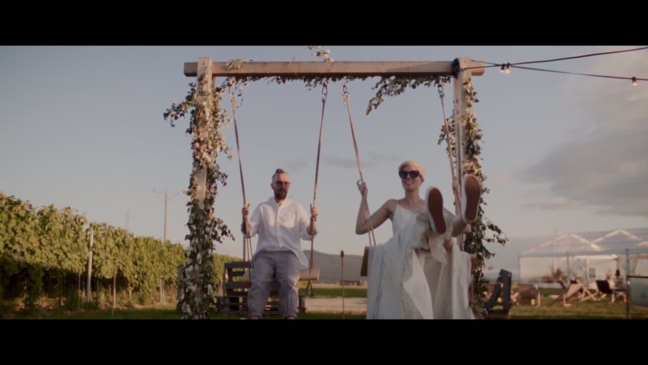 Couple enjoying a romantic swing at a vineyard wedding