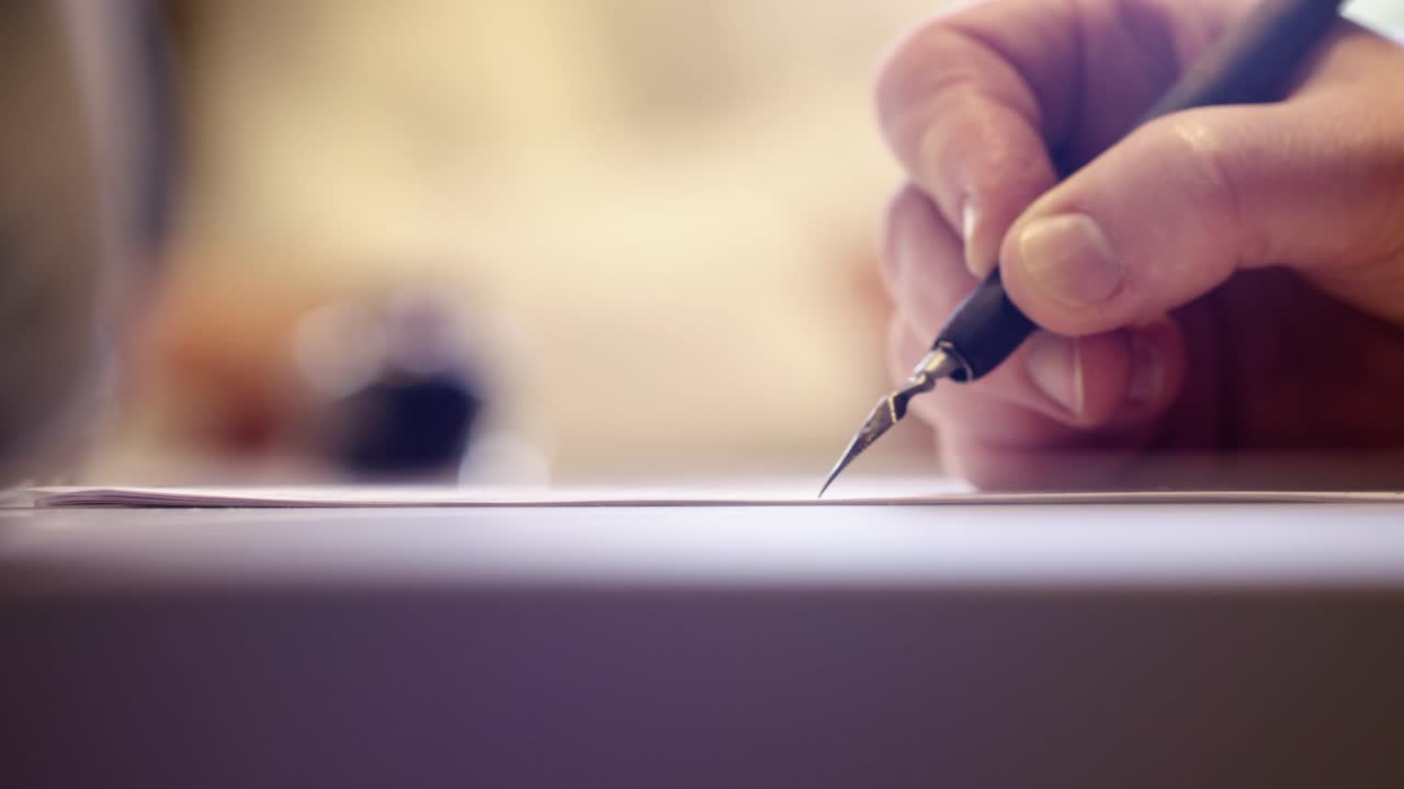 female  hand writting oldschool black ink pen on the white sheet of paper close  up slow motion at the office
