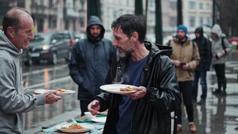 street food distribution to homeless people on a rainy day