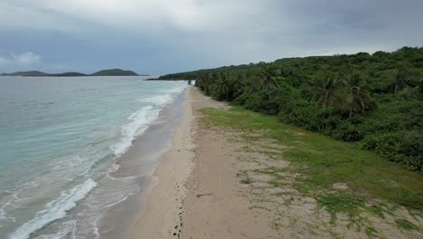 tropical beach on cloudy day in caribbean- zoni beach, culebra puerto rico -aerial pull back