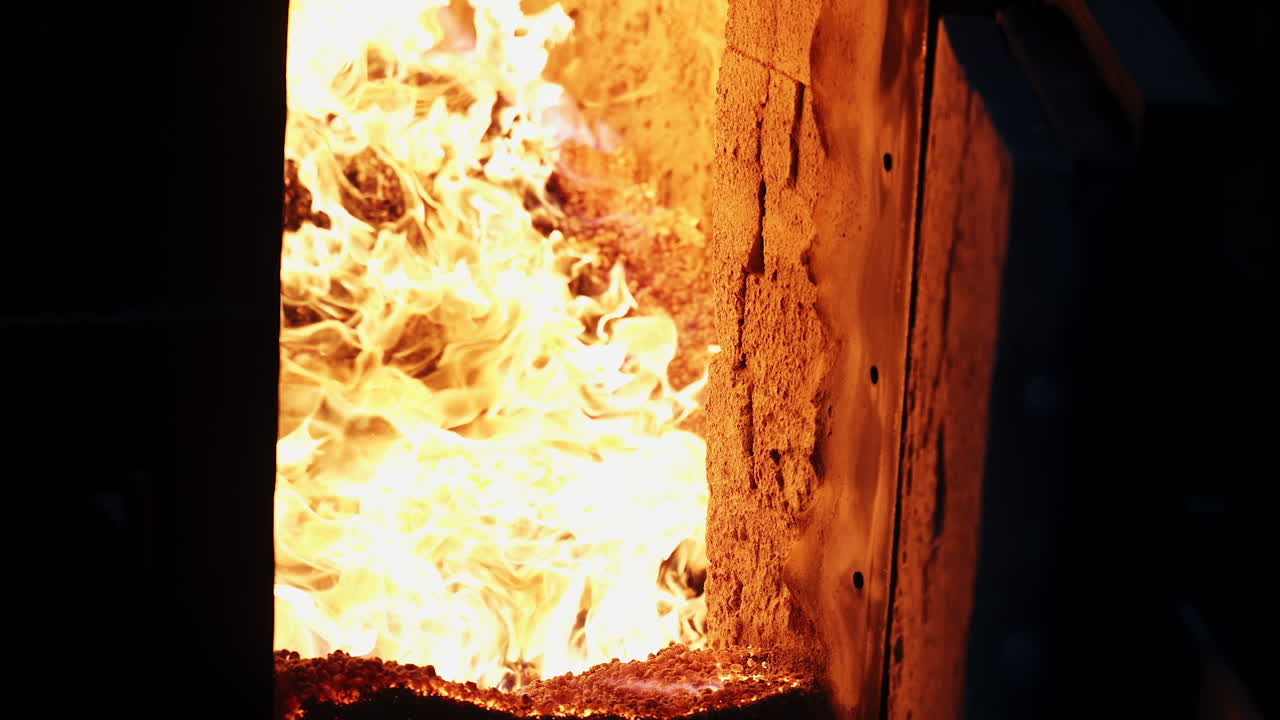 Burning wood chip pellets a renewable source. Burning wood chip pellets a renewable source, modern wood-burning stove to heat house in winter