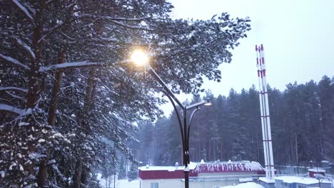 snowy winter landscape with streetlight and chimney