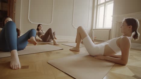 mujeres practicando yoga en un estudio