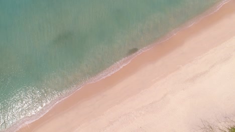 aerial view top view of beautiful tropical sea sandy beach and waves crashing against sand beach from above beautiful sea surface at phuket patong beach is famous tourist destination