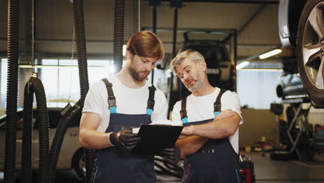 mechanics reviewing documents in a garage