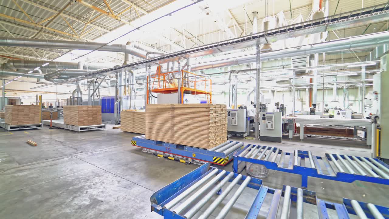 An electric loader puts on the metal pallet a pile of parquet boards under the client's order in the warehouse.