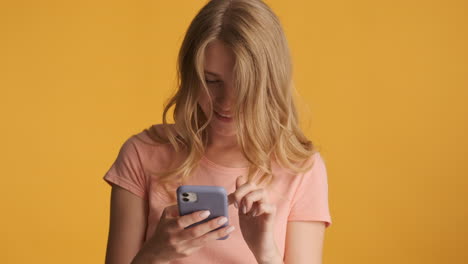 caucasian woman using smartphone and getting excited on camera.