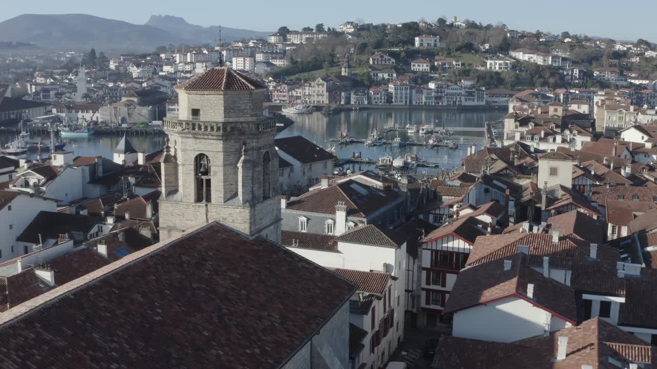 Saint-Jean-Baptiste church, Saint-Jean-de-Luz historic centre, cityscape, France. Aerial forward descending