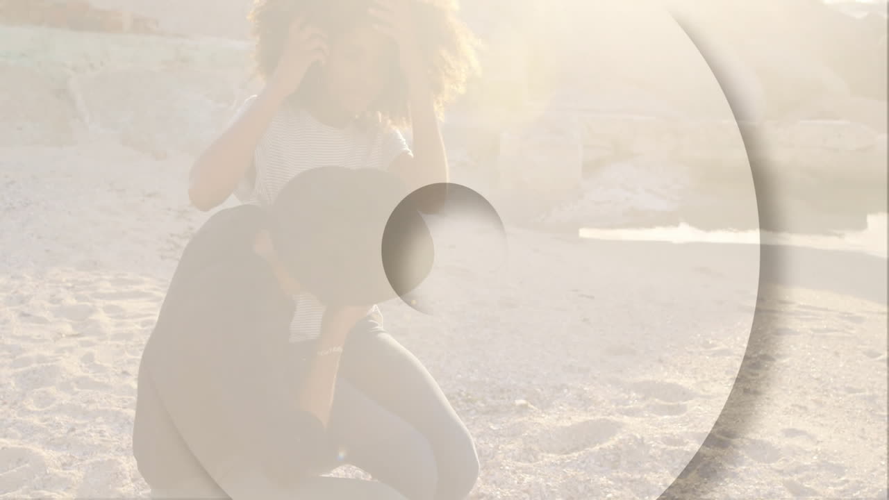 Animation overlaying scene, couple walking on beach with abstract shapes