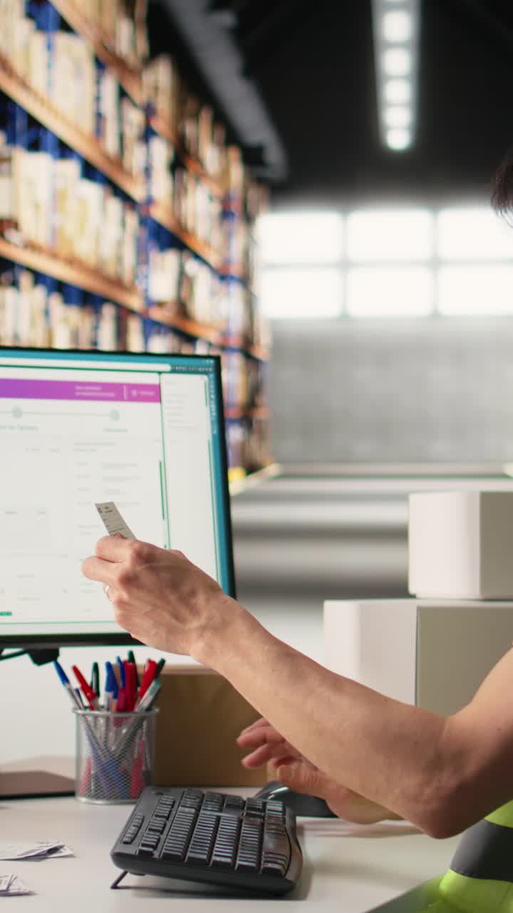 Vertical Video Asian employee typing tracking info from airway bill labels