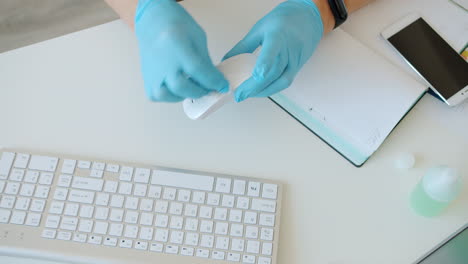 cleaning a workstation with gloves