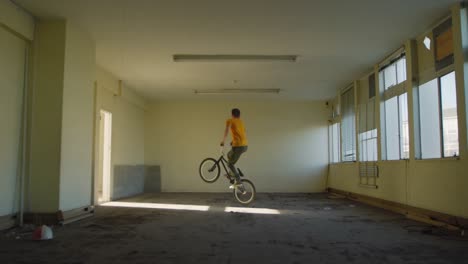 bmx rider in an empty warehouse