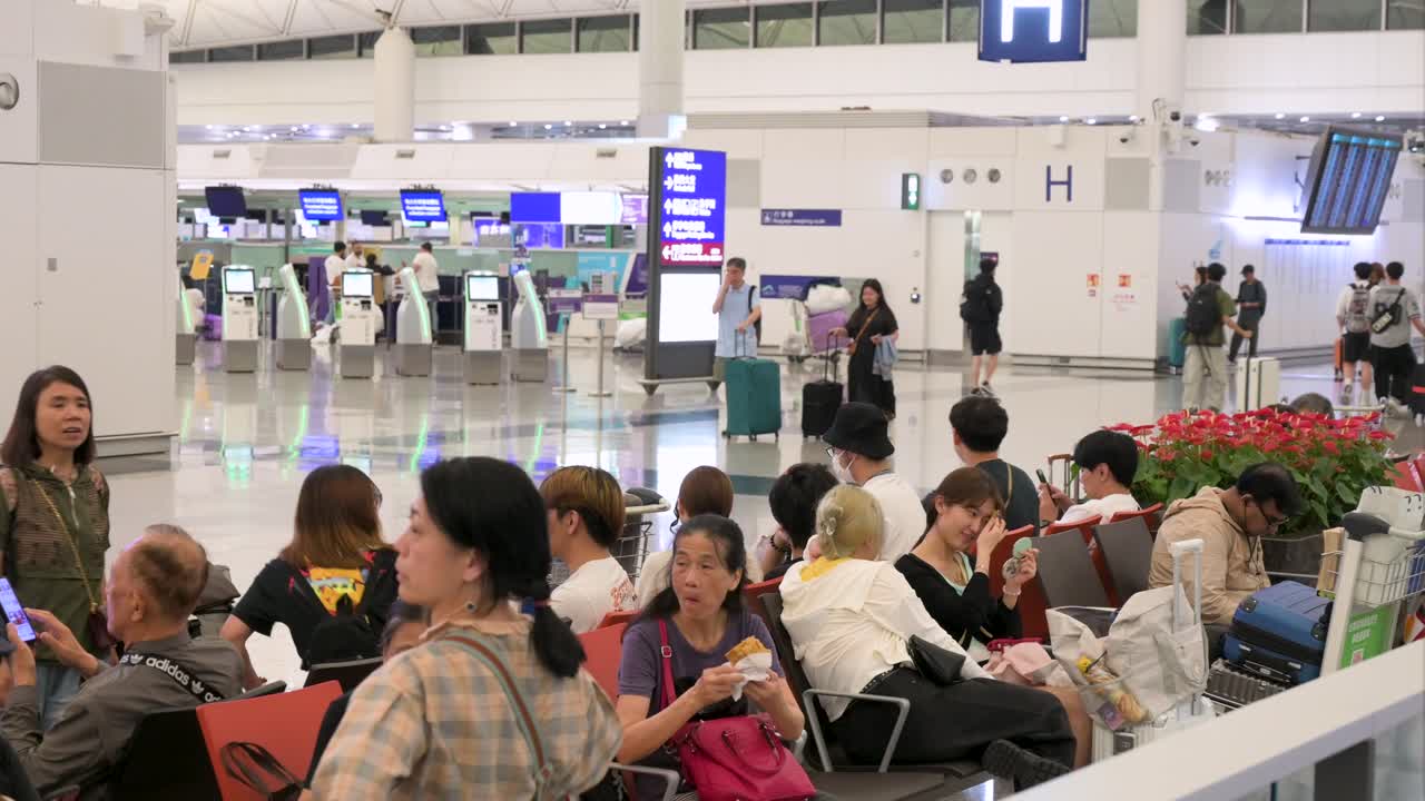 People waiting in a busy airport terminal