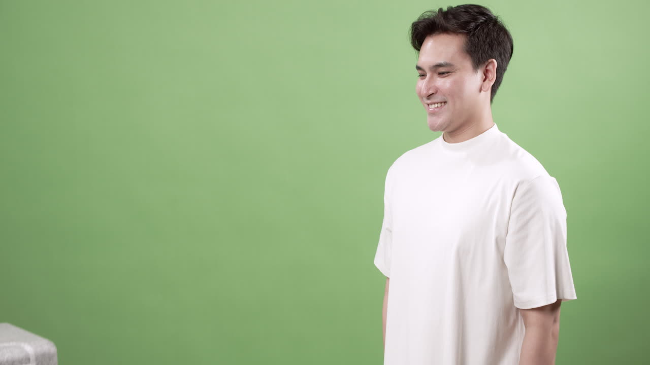A young man joyfully accepts a package in an indoor space highlighting the excitement of delivery.