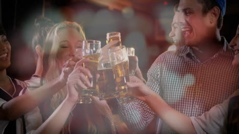 Group of friends raising beer glasses in bar, showing floating social icons for marketing