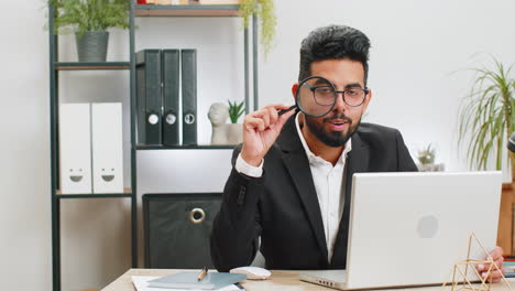 Business-man-holding-magnifying-glass-near-face,-looking-with-big-zoomed-eye,-searching,-analyzing