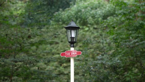 Close-up of cute vintage lamp with red &#039;The Dam&#039; sign, in 4K