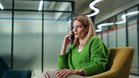 confident businesswoman talking cellphone in office. lady calling mobile phone