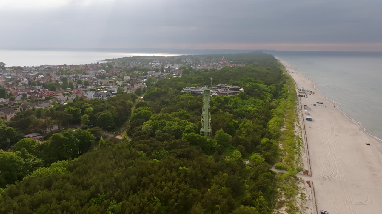 Aerial view circling a watchtower at a beach in Jastarnia, summer in Hel, Poland