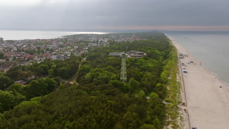 aerial view circling a watchtower at a beach in jastarnia, summer in hel, poland
