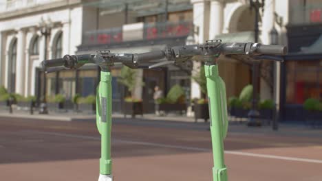 Top-view-of-two-electric-scooters-in-downtown-Grand-Rapids,-Michigan-with-stable-video-close-up