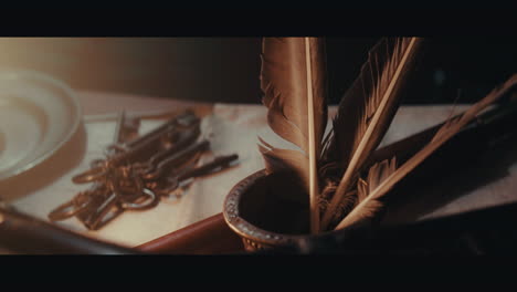 an old inkwell with quills for writing on the table filled with documents and maps inside the sailing ship cabin