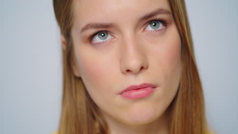 Closeup-pensive-woman-choosing-idea-at-camera-on-grey-background.-Thinking-girl