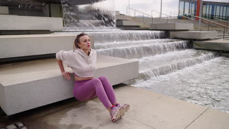 woman exercising outdoors near a fountain