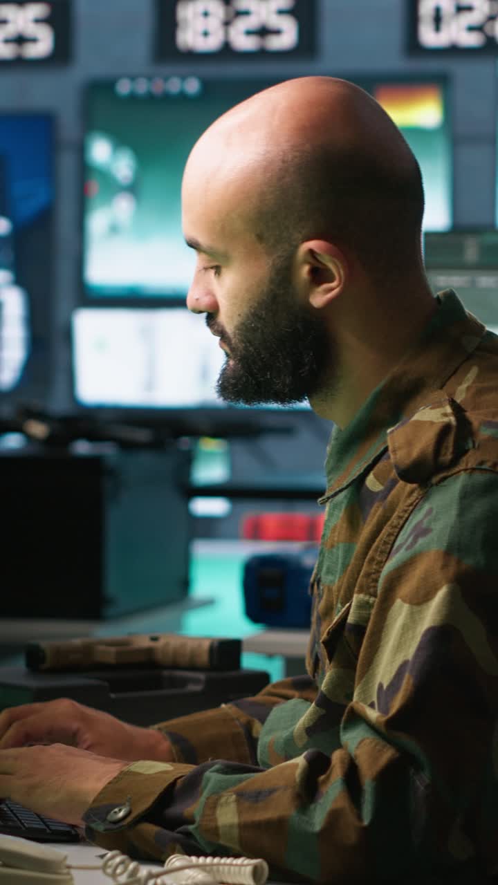 Vertical video Man looking at screens in military HQ base intercepting ballistic rockets