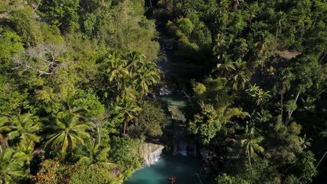 above cambugahay falls in dense tropical jungle, blue water pool, aerial