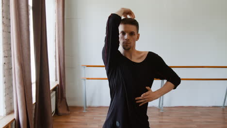 male dancer practicing elegant movements in a studio