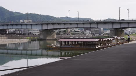 nagara-gawa river and bridge with boats along bank, gifu japan