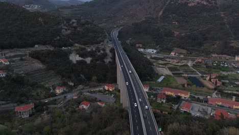 Aerial-of-Cars-driving-over-high-overpass-between-mountains