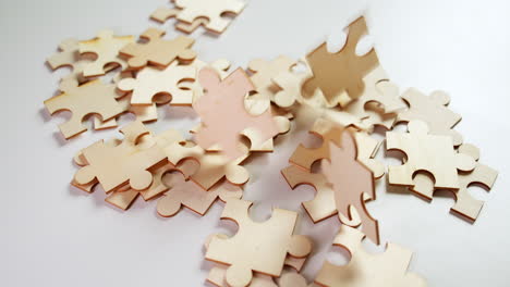 close-up shot of pieces of a puzzle related to business, marketing, investments, management, networking, and other things pertaining to economics