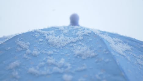 snow on a blue umbrella