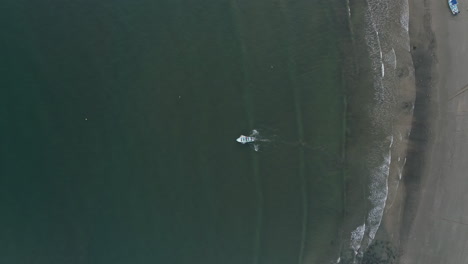 Top-down-aerial-as-boat-bounces-through-waves-to-try-to-make-it-out-to-sea,-4K