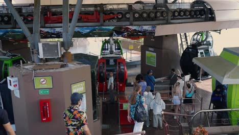 people waiting in line for cable car ride at mountaintop station