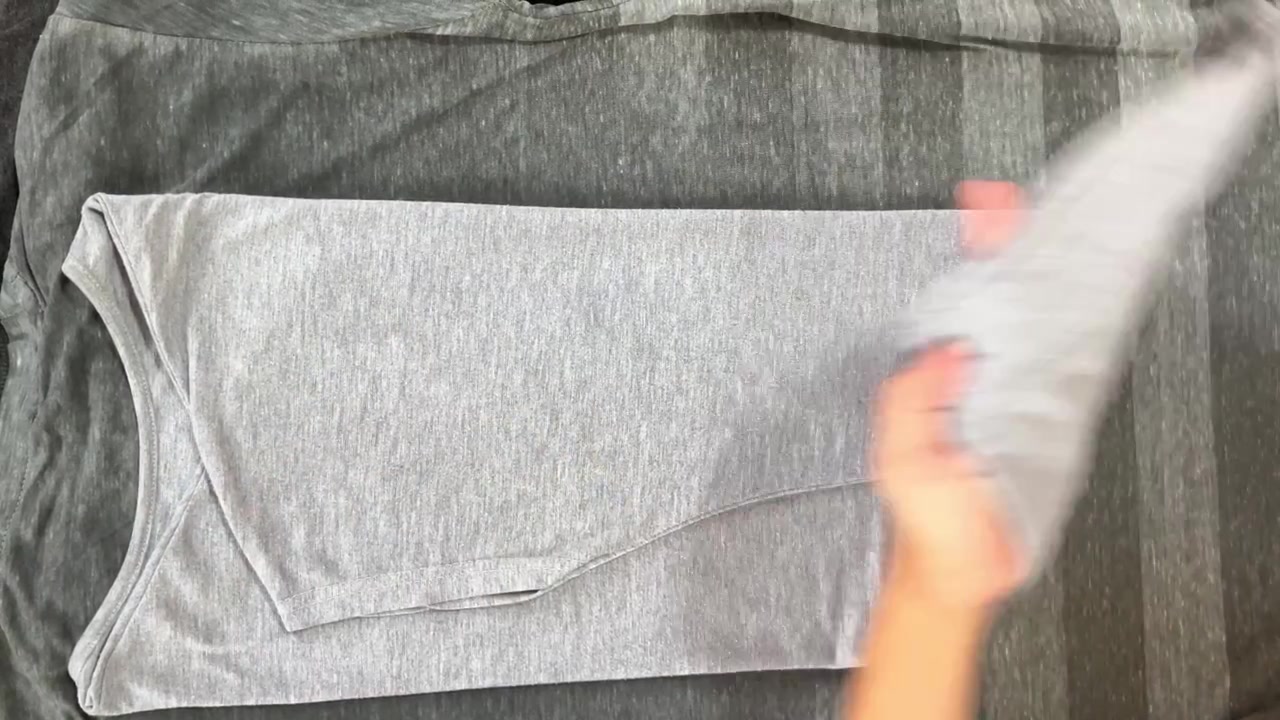 4K close-up of female hands using an iron to smooth fabric. Essential housework, laundry routine, and domestic lifestyle footage.